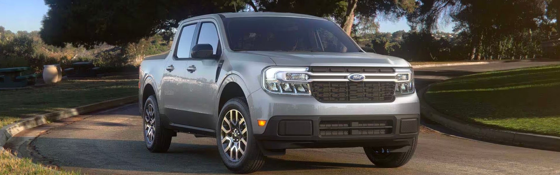 A silver truck sitting parked.
