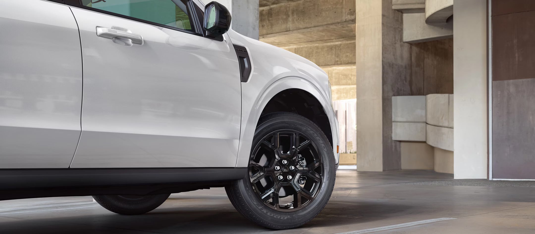 An upclose view up a white trucks side profile.