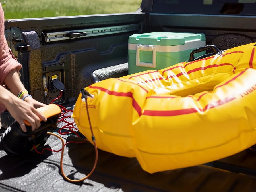a yellow tube being inflated in the bed of a truck