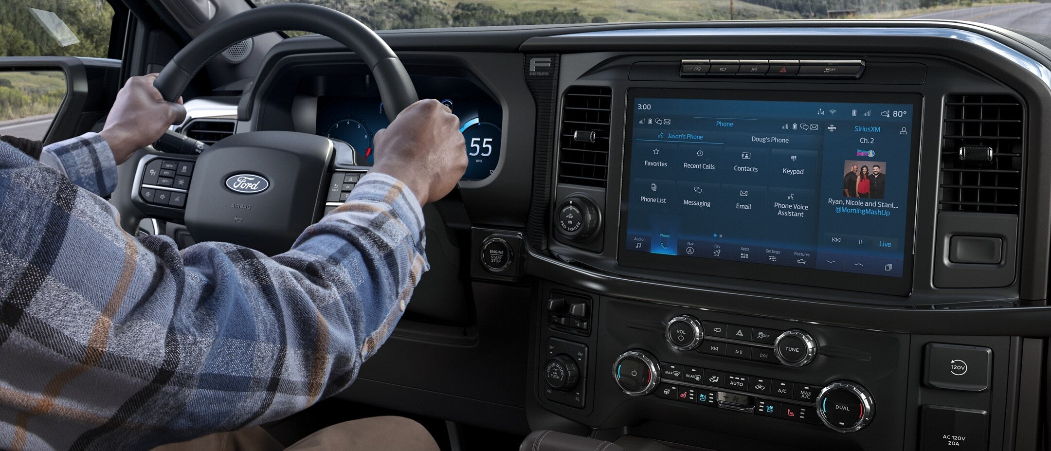 a person driving a ford f-150 with infotainment screen displaying home screen