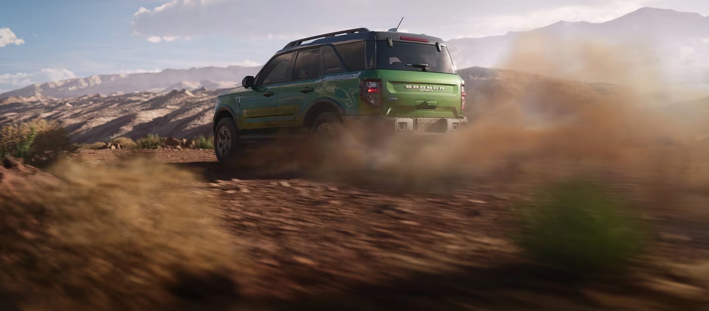 A green bronco sport driving off-road.