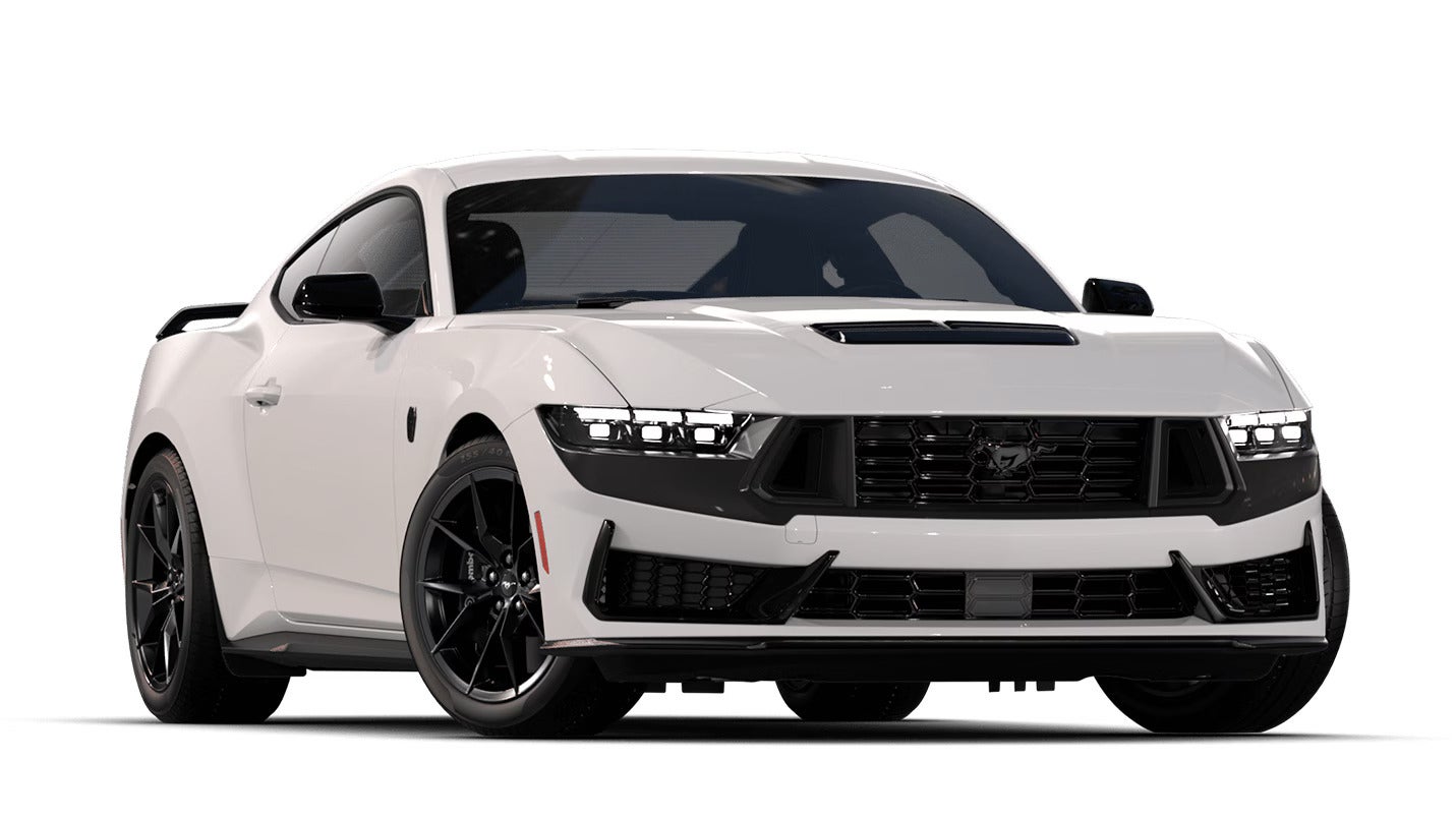 Front view of a white 2025 Ford Mustang with a black grille and sleek headlights.