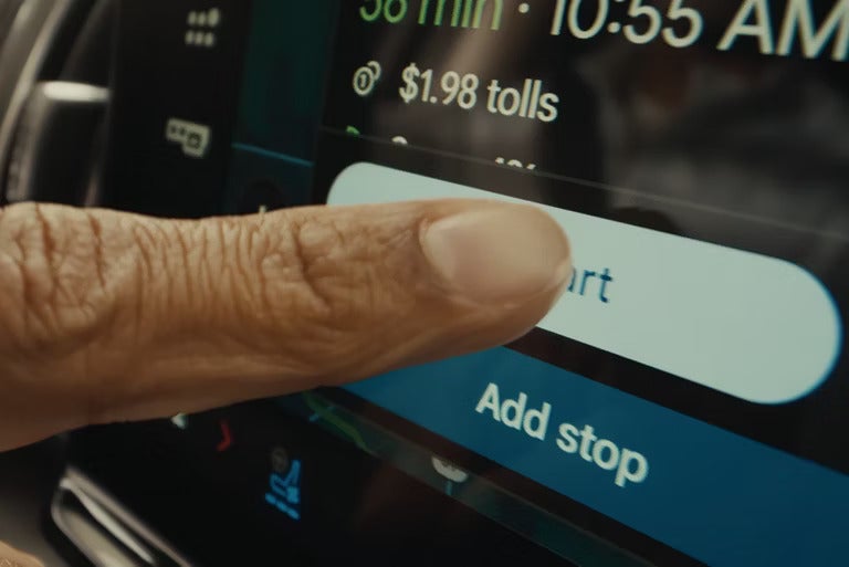 a person using the infotainment screen for navigation in a 2026 ford expedition