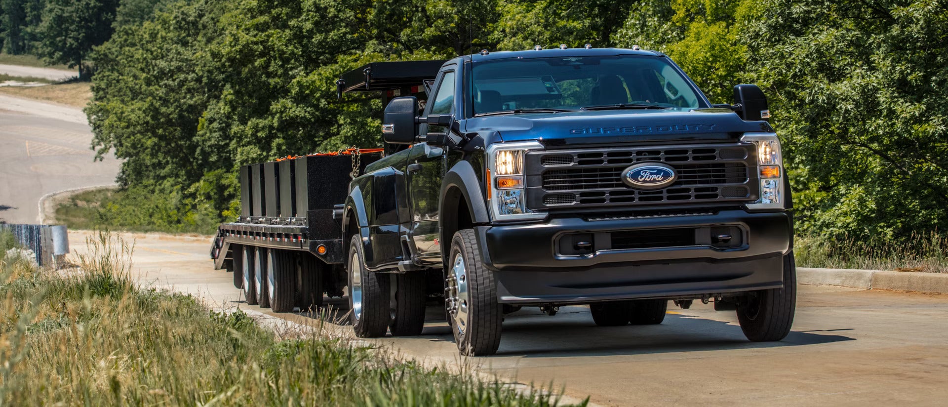 a 2026 Ford Super Duty hauling a Trailer up a road