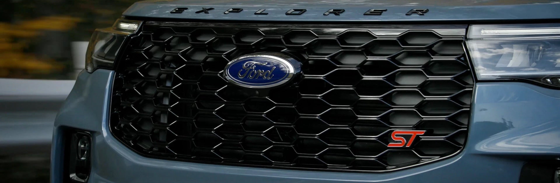 Front grill of a 2025 light navy/gray Ford Explorer ST.